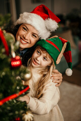Mother and daughter enjoying christmas holiday with elf hat