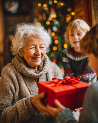 Grandmother Receiving a Christmas Gift from Loving Grandchildren