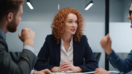 Female boss leads intense business meeting with male colleagues showing leadership power this is a very important and serious corporate discussion this is a great teamwork process - Powered by Adobe