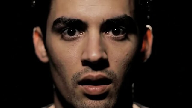 Intense Close-up A Man's Fearful Expression in Darkness