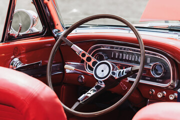 Close up shot of steering wheel on a red vintage car © SNEHIT PHOTO