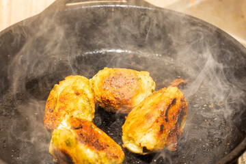 Zero oil Indian cooking on cast iron pan – healthy oil-free lifestyle concept