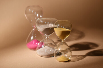 Crystal hourglasses on beige background