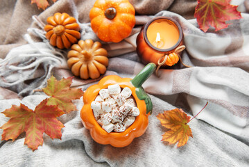 Pumpkin mug of hot chocolate with marshmallows cozy autumn scene