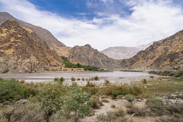 Scenic mountain landscape view of Panj river valley in summer, Darvaz, Gorno-Badakhshan, Tajikistan Pamir	
