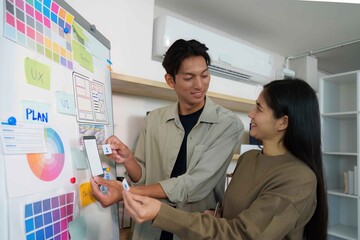 Creative Collaboration. Young professionals discussing UI design ideas.