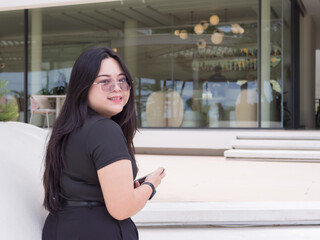 Confident Asian woman with real body smiles while enjoying casual day out. Body positive concept.
