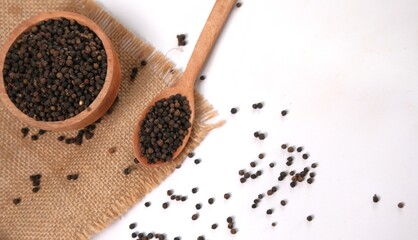 Black Peppercorns: Culinary Spice on Burlap and White