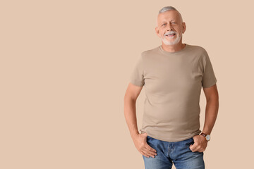 Fototapeta premium Portrait of senior man on beige background