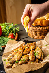 Hand squeezing lemon over fried fish