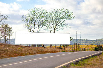 Obraz premium Large billboard on the side of the asphalt road in the countryside. White and empty advertising poster. Blank banner, billboard. Copy space. Text area. 