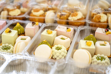 Assorted mini desserts in plastic takeaway boxes