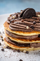 Stack of pancakes with chocolate cream and cookie