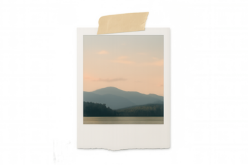 Instant print showing calm lake with mountains, embodying travel memories and cherished nostalgia