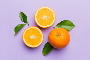 Fruit pattern of fresh orange slices on colored background. Top view. Copy Space. creative summer concept. Half of citrus in minimal flat lay
