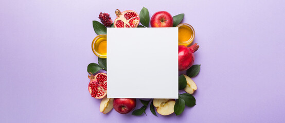 Flat lay composition with Blank flyer poster and symbols jewish Rosh Hashanah holiday attributes on colored background, New Year holiday Traditional. Top view with copy space mock up