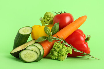 Different fresh vegetables on green background. World Vegan Day