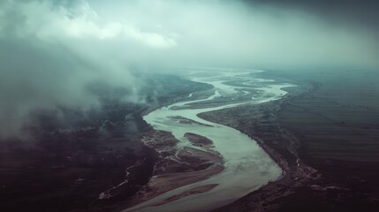 Aerial River Landscape: Winding Waterway Through Misty Valley