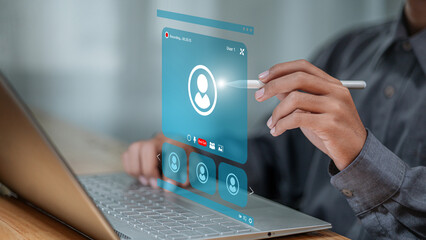 Businessman Using Stylus with Virtual Video Conference Interface on Laptop