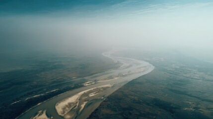 Aerial View of River in Misty Landscape