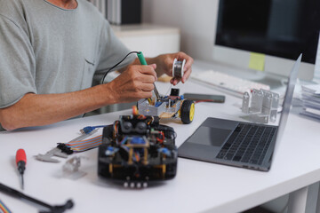 Person soldering electronic components for a robot