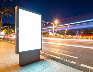Light box display with white blank space for advertisement. Mock-up design concept with beautiful car light trails at night. Long exposure.