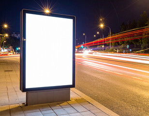 Light box display with white blank space for advertisement. Mock-up design concept with beautiful car light trails at night. Long exposure.