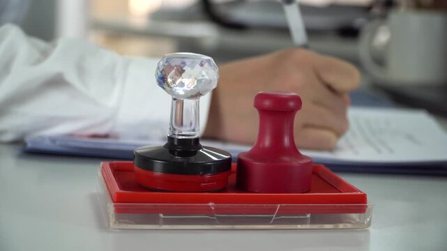 Businessman signing and stamping contract document in office