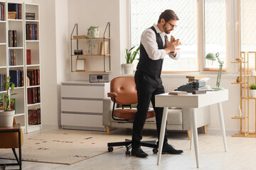 Young  male writer with vintage typewriter and crumpled paper working in office