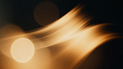 Abstract golden light streaks on dark background