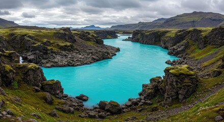 A vibrant turquoise river winds through dramatic volcanic landscapes, showcasing a stunning natural vista.