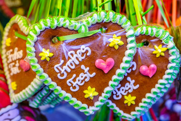 typical ginger bread heart at a kiosk in munich - translation: happy christmas