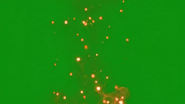 Floating fire sparks and embers on a green screen background for visual effects and motion design