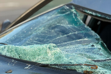 A broken windshield of a car as a result of a traffic accident. Dangerous, careless, unsafe, drunk,...
