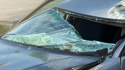 A broken windshield of a car as a result of a traffic accident. Dangerous, careless, unsafe, drunk,...