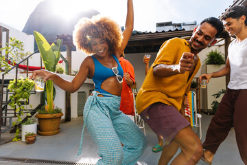 Group of friends dancing outdoors in the summertime