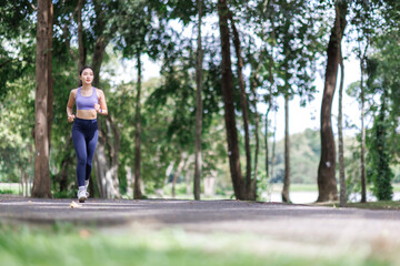 Young woman jogging in park, pursuing active healthy lifestyle