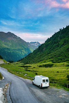 Camper van with solar panels traveling in the Austrian alps