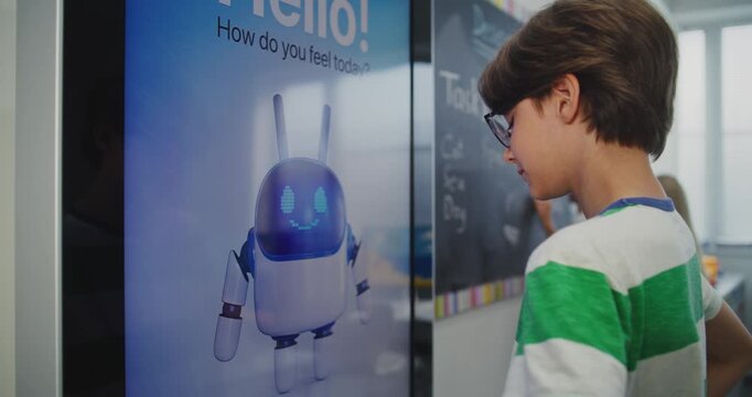 Close Up of Schoolchild in Good Mood Interacting With AI Based Mood Tracking Tool in Modern Classroom. Concept of Integrating Educational Technologies and Supporting Mental Health. Static Shot.