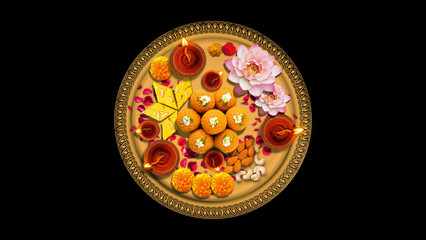 Traditional Festive Thali Decorated with Diyas and Sweets on Black Background