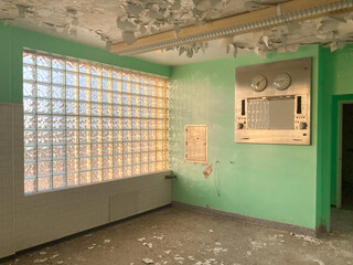 Decrepit room with peeling paint inside an abandoned and haunted hospital 