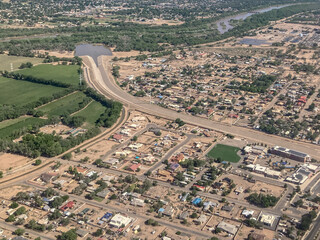 Overhead, aerial view of south Albuquerque, New Mexico, USA showing the Rio Grande River and an arroyo