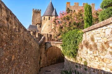 Stone towers and ramparts of Carcassonne citadel at sunday.