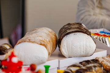 Freshly baked bread loaves with chocolate and icing at market stall