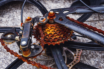 Parts of an old bicycle in the village. Close Up Rusty old bicycle chain sprocket, spokes of the wheel. Old bicycle wheel with rusted chain