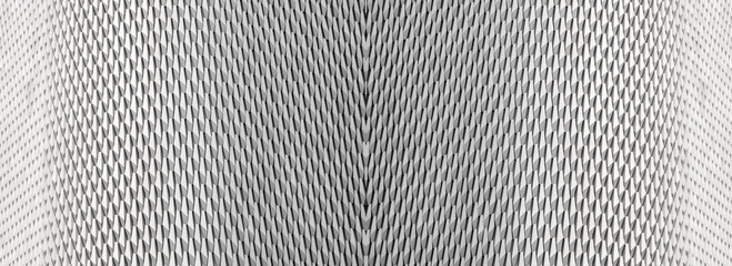 geometric pattern of interlocking, triangular metallic shapes in varying shades of gray