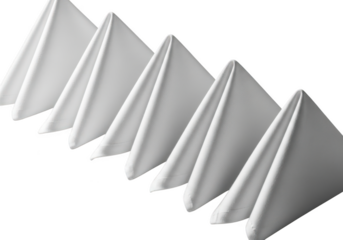 Neatly folded white cloth napkins arranged diagonally on a dark surface for formal dining isolated on transparent background