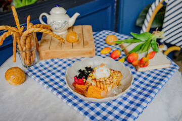 A beautifully arranged dessert with various elements displayed on a table setting