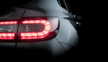 Close-up shots of modern car tail lights glowing in the dark, showcasing sleek LED designs, luxury styling, and advanced automotive lighting technology