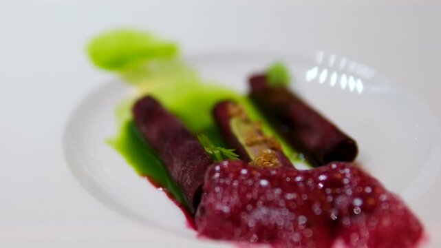 Close-up molecular beet foam dish on Virgin Voyages Test Kitchen served aboard Scarlet Lady artistic plating vibrant beet foam culinary experimental dining cruise ship fine cuisine
